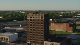 DX0001_000676 - 5.7K aerial stock footage a stationary view of an abandoned office building at sunset in East St. Louis, Illinois