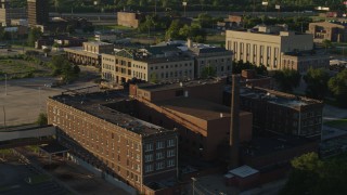 DX0001_000683 - 5.7K aerial stock footage orbit abandoned hospital across from a federal courthouse at sunset in East St. Louis, Illinois