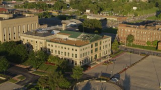 DX0001_000685 - 5.7K aerial stock footage of approaching a federal courthouse at sunset in East St. Louis, Illinois