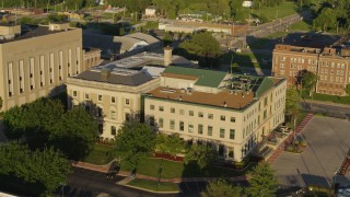 DX0001_000686 - 5.7K aerial stock footage of orbiting the side of a federal courthouse at sunset in East St. Louis, Illinois
