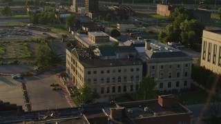 DX0001_000690 - 5.7K aerial stock footage of circling around a federal courthouse at sunset in East St. Louis, Illinois