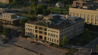 DX0001_000691 - 5.7K aerial stock footage of flying around a federal courthouse at sunset in East St. Louis, Illinois