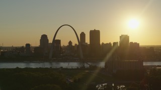 DX0001_000697 - 5.7K aerial stock footage of the setting sun behind the Downtown St. Louis, Missouri skyline