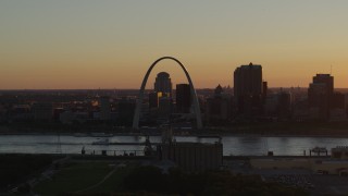 DX0001_000714 - 5.7K aerial stock footage a view across the river of the Gateway Arch and Downtown St. Louis, Missouri at sunset