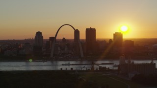 DX0001_000715 - 5.7K aerial stock footage of the Gateway Arch and Downtown St. Louis, Missouri skyline with the setting sun in the background