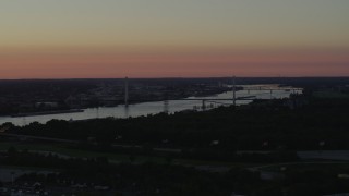 DX0001_000727 - 5.7K aerial stock footage of the Stan Musial Veterans Memorial Bridge and Mississippi River at sunset in St. Louis, Missouri
