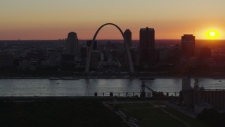 DX0001_000729 - 5.7K aerial stock footage of the Gateway Arch in silhouette in Downtown St. Louis, Missouri, sunset
