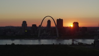 DX0001_000734 - 5.7K aerial stock footage of the sun setting behind Downtown St. Louis, Missouri and the Gateway Arch