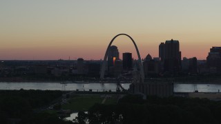 DX0001_000737 - 5.7K aerial stock footage of looking across the river at the Gateway Arch and Downtown St. Louis, Missouri, sunset