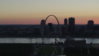 DX0001_000740 - 5.7K aerial stock footage Gateway Arch seen from grain elevator across the river, and fountains, Downtown St. Louis, Missouri, twilight