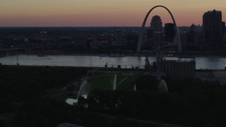 DX0001_000741 - 5.7K aerial stock footage of the Gateway Geyser with the Arch across the river, Downtown St. Louis, Missouri, twilight