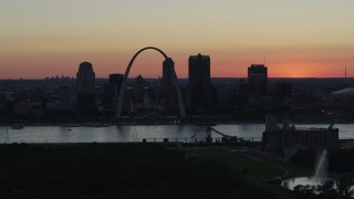 DX0001_000744 - 5.7K aerial stock footage of the Gateway Arch in Downtown St. Louis, Missouri at twilight, and the Gateway Geyser fountain
