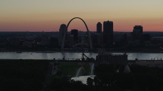 DX0001_000745 - 5.7K aerial stock footage of Gateway Geyser, and the Gateway Arch in Downtown St. Louis, Missouri, twilight