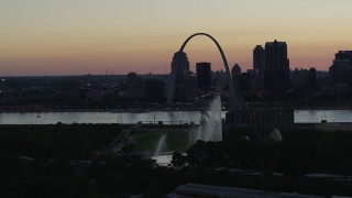 DX0001_000752 - 5.7K aerial stock footage fly away from Gateway Geyser, with view of Downtown St. Louis, Missouri, twilight