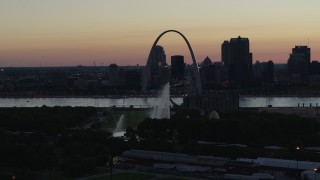 DX0001_000753 - 5.7K aerial stock footage of the Gateway Geyser and Arch while descending, Downtown St. Louis, Missouri, twilight