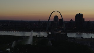 DX0001_000763 - 5.7K aerial stock footage pass the Gateway Geyser with view of Downtown St. Louis, Missouri, twilight