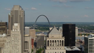 DX0001_000794 - 5.7K aerial stock footage of Gateway Arch seen while flying by buildings in Downtown St. Louis, Missouri