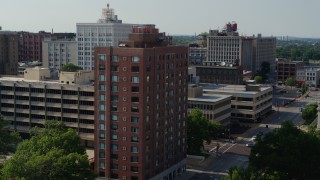 DX0001_000801 - 5.7K aerial stock footage of a stationary view of brick office building before approach in Downtown St. Louis, Missouri