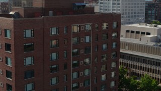 DX0001_000802 - 5.7K aerial stock footage of a slow approach to a brick office building in Downtown St. Louis, Missouri