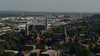 DX0001_000826 - 5.7K aerial stock footage of flying away from three brick churches in St. Louis, Missouri