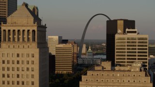 DX0001_000840 - 5.7K stock footage aerial video flyby office buildings, reveal Gateway Arch and museum at sunset, Downtown St. Louis, Missouri