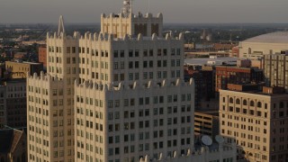 DX0001_000841 - 5.7K aerial stock footage of flying away from an apartment building at sunset, Downtown St. Louis, Missouri