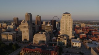 DX0001_000845 - 5.7K aerial stock footage of flying by courthouses to reveal Gateway Arch and museum at sunset, Downtown St. Louis, Missouri