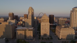 DX0001_000856 - 5.7K aerial stock footage fly away from courthouse with Arch in background at sunset, Downtown St. Louis, Missouri
