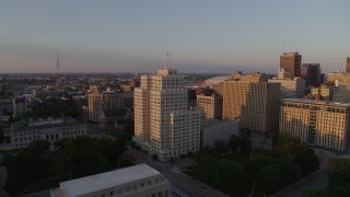 DX0001_000857 - 5.7K aerial stock footage fly away from a tall apartment building, reveal museum at sunset, Downtown St. Louis, Missouri