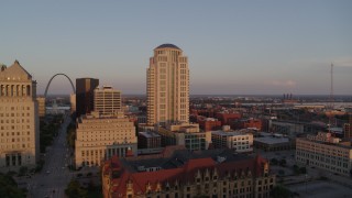 DX0001_000859 - 5.7K aerial stock footage flyby courthouse buildings to reveal the Arch at sunset, Downtown St. Louis, Missouri