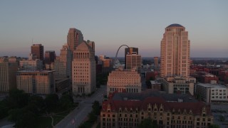 DX0001_000869 - 5.7K aerial stock footage of passing courthouses with view of the Arch, reveal city hall at sunset, Downtown St. Louis, Missouri