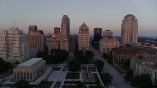 DX0001_000875 - 5.7K aerial stock footage of an approach to a courthouse, and ascend to reveal the Arch at sunset, Downtown St. Louis, Missouri