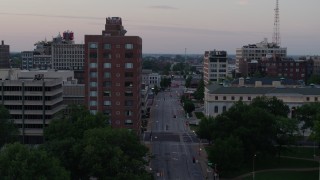 DX0001_000878 - 5.7K aerial stock footage of passing an office building and an empty street at twilight, Downtown St. Louis, Missouri