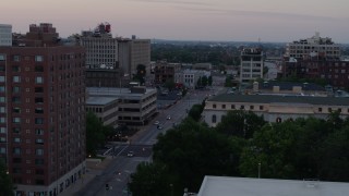 DX0001_000880 - 5.7K aerial stock footage flyby brick office building to reveal light street traffic at twilight, Downtown St. Louis, Missouri