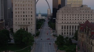 DX0001_000882 - 5.7K aerial stock footage of light street traffic and courthouses, reveal the Gateway Arch at twilight, Downtown St. Louis, Missouri