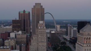 DX0001_000890 - 5.7K aerial stock footage fly past skyscrapers with a view of the Gateway Arch at twilight, Downtown St. Louis, Missouri