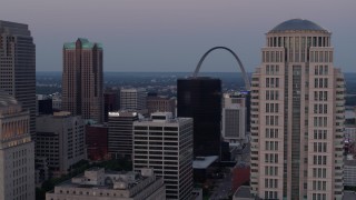 DX0001_000892 - 5.7K aerial stock footage flyby courthouse skyscraper and reveal the Gateway Arch at twilight in Downtown St. Louis, Missouri