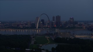 DX0001_000895 - 5.7K aerial stock footage of the Gateway Arch at twilight, visible from across the Mississippi River, Downtown St. Louis, Missouri