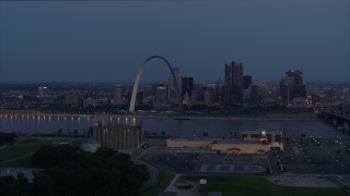 DX0001_000897 - 5.7K aerial stock footage of the Gateway Arch at twilight seen from across the Mississippi River, Downtown St. Louis, Missouri