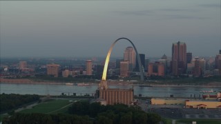 DX0001_000941 - 5.7K stock footage aerial video of sunlight on the St. Louis Arch by the river at sunrise in Downtown St. Louis, Missouri