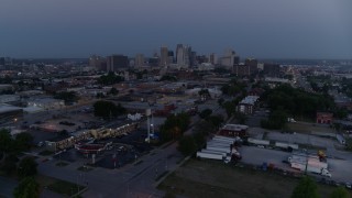 DX0001_000976 - 5.7K aerial stock footage of the city skyline at twilight, seen from industrial area in Downtown Kansas City, Missouri