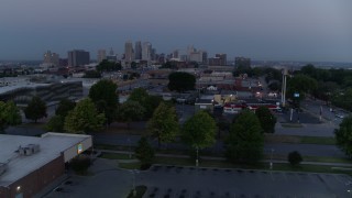 DX0001_000980 - 5.7K aerial stock footage of a view of skyline at twilight while descending to parking lot, Downtown Kansas City, Missouri