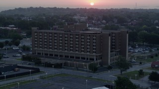 DX0001_000989 - 5.7K aerial stock footage of approaching a brick office building at sunrise in Kansas City, Missouri
