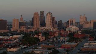 DX0001_000996 - 5.7K aerial stock footage of approaching the city skyline at sunrise, Downtown Kansas City, Missouri