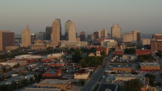 DX0001_001003 - 5.7K aerial stock footage of flying by the city skyline at sunrise, Downtown Kansas City, Missouri
