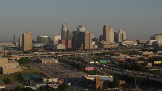 DX0001_001017 - 5.7K aerial stock footage of the downtown skyline at sunrise and freeway interchange, Downtown Kansas City, Missouri