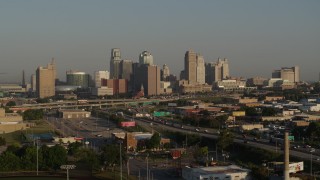 DX0001_001018 - 5.7K aerial stock footage flyby the downtown skyline and freeway interchange at sunrise, Downtown Kansas City, Missouri