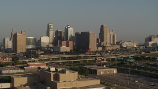DX0001_001021 - 5.7K aerial stock footage reverse view of the downtown skyline and Hwy 71 at sunrise, Downtown Kansas City, Missouri
