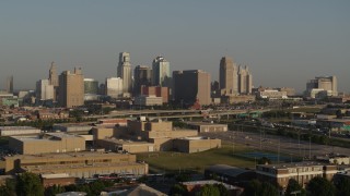 DX0001_001026 - 5.7K aerial stock footage flyby the downtown skyline at sunrise, seen from tech school in Downtown Kansas City, Missouri