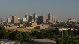 DX0001_001027 - 5.7K aerial stock footage of the downtown skyline at sunrise, seen while descending near tech school in Downtown Kansas City, Missouri